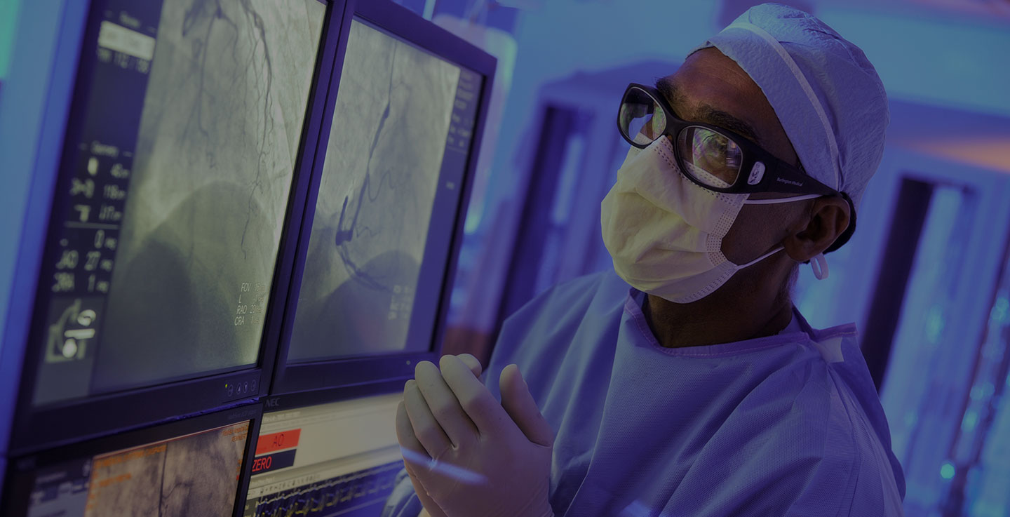 A surgical oncologist in full operating gear performs an innovative new cancer treatment procedure 