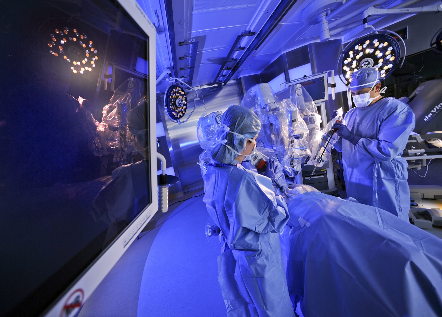 Two surgical oncologists perform one of the latest and most innovative surgical procedures for cancer in an operating room