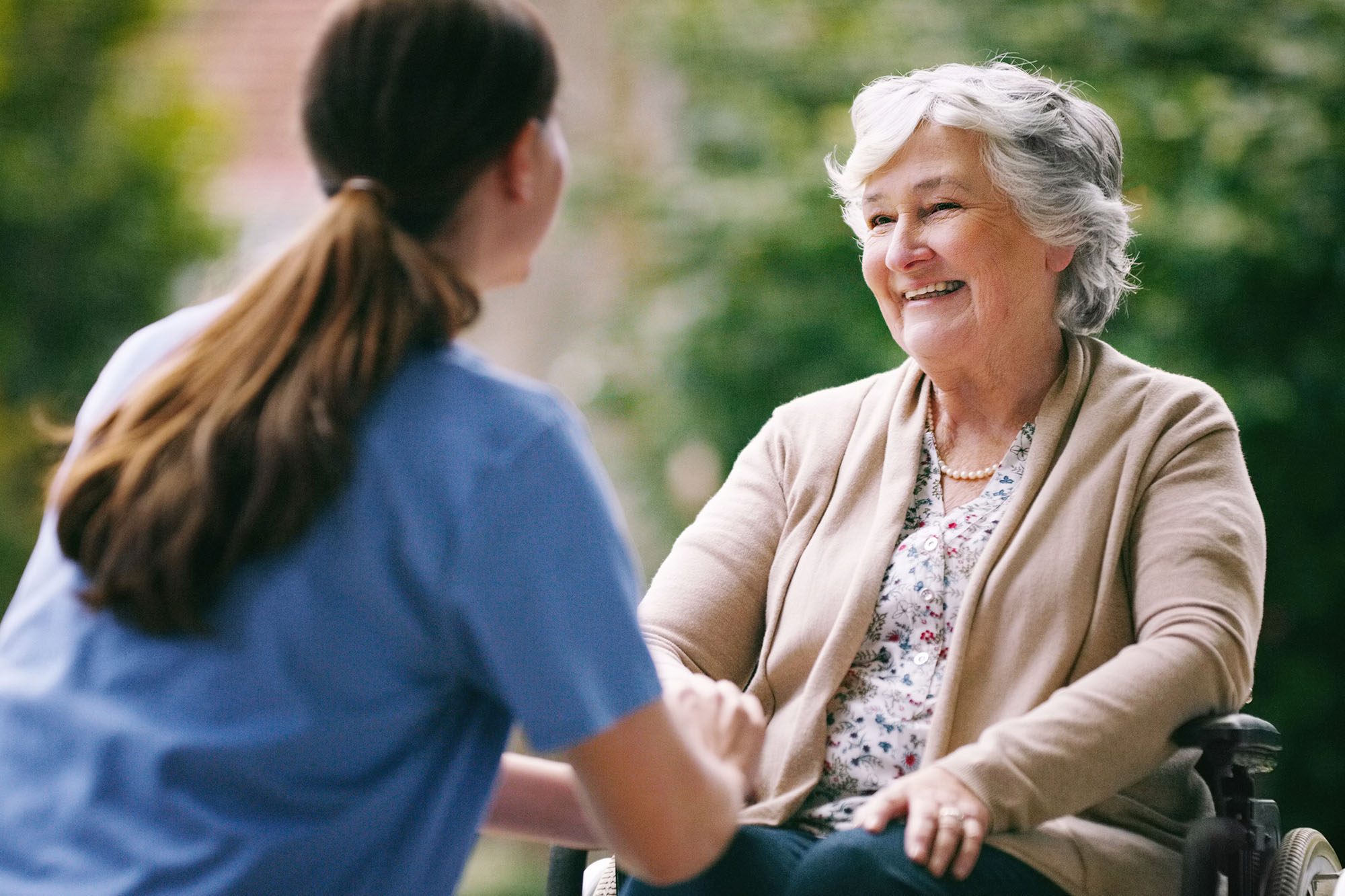 An older woman with her caretaker.