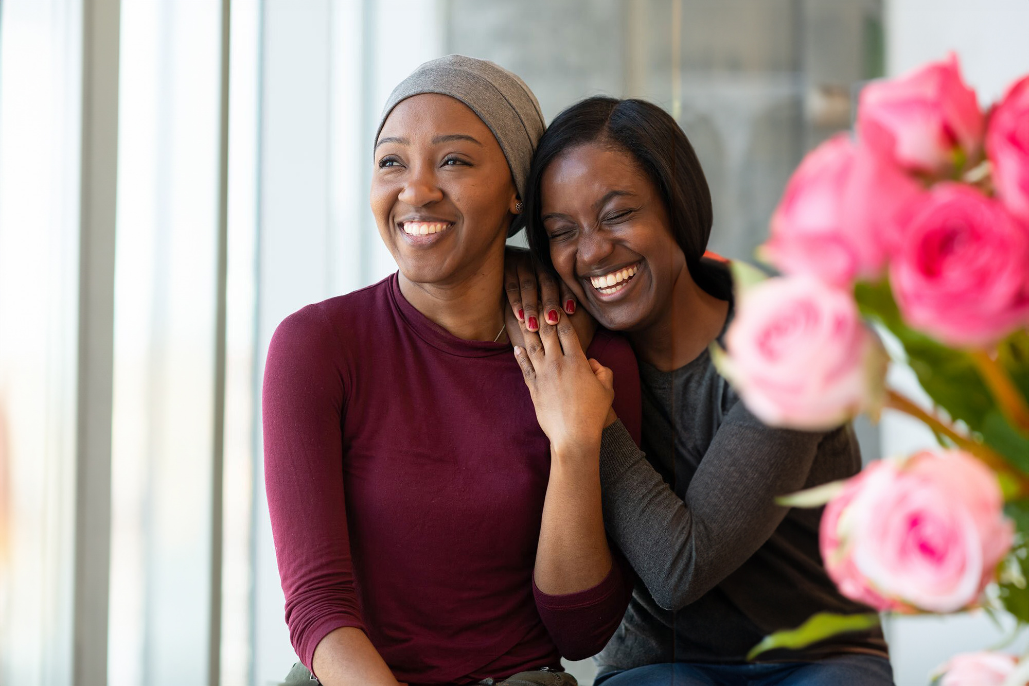 Two Women Hugging and Smiling