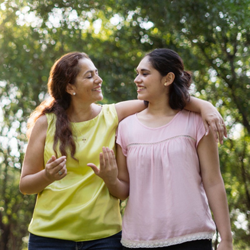 Two hispanic women walking together.