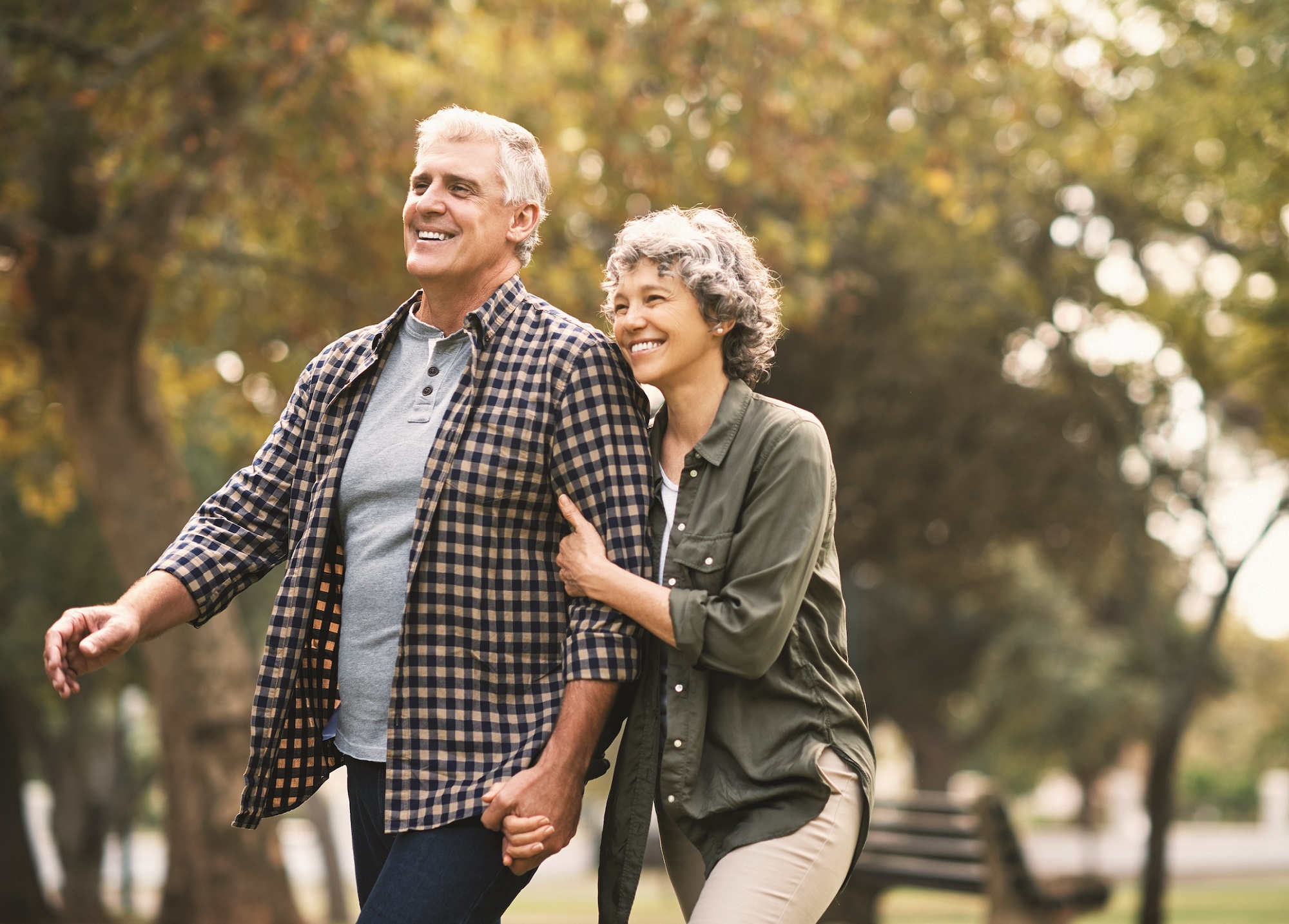 A Couple Walks Through a Park