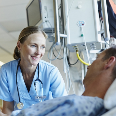 A nurse navigator explains the patient education resources available at to a cancer patient